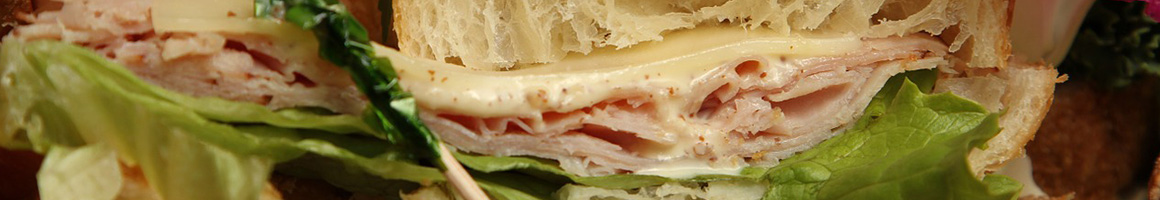 Eating Deli Italian Sandwich at Caruso's Italian Fine Foods restaurant in Halesite, NY.